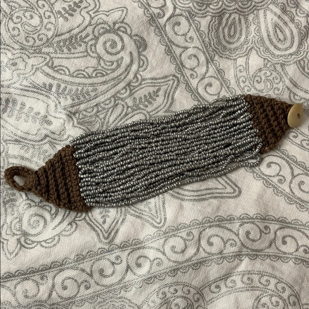 Silver multi string bracelet with knitted closure